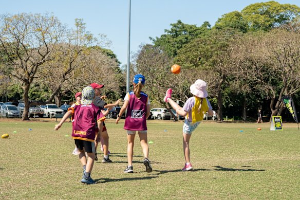 Kids taking part in AFL training workshops at New Farm Park.