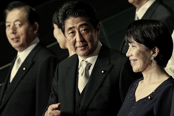 Takaichi with then PM Shinzo Abe, centre, in 2014. She has taken a leaf from his economic policies.
