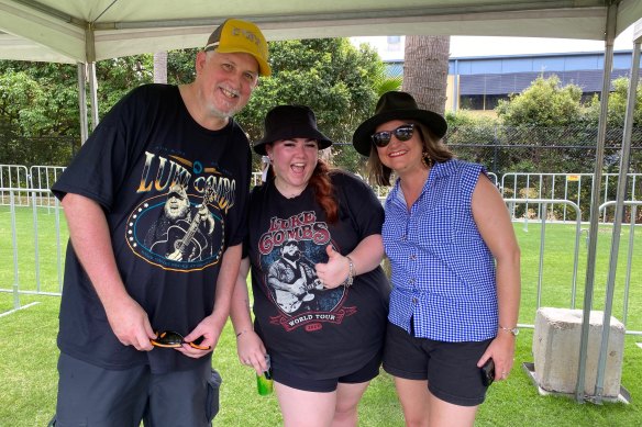 Luke Climes and Jessica Mitchell, both from Morayfield, and Sally Farquhar (right) from West End queue outside Suncorp Stadium on Friday.