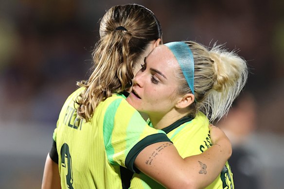 Wini Heatley gets a hug from Ellie Carpenter at full-time in Gosford.