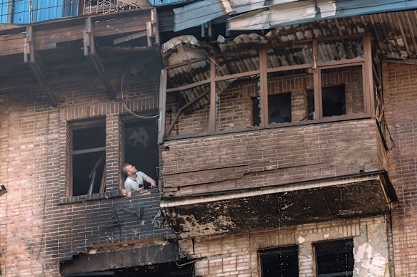 A Ukrainian man inspects damage to apartments after a Russian air strike in Kyiv this month.