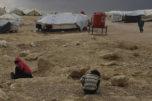 Children play among the rocks in the foreign annex of al-Hawl camp in Syria in 2019.