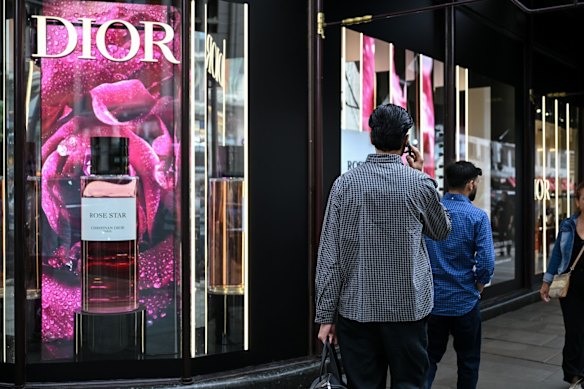 A shopper talks on his phone near the Harrods department store in London.