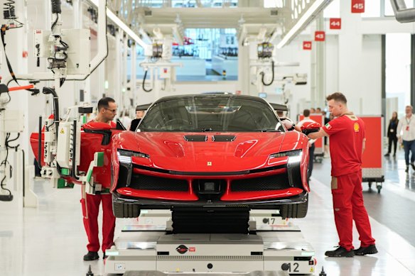 Workers on the production line at the new Ferrari NV E-building factory in Maranello, Italy.