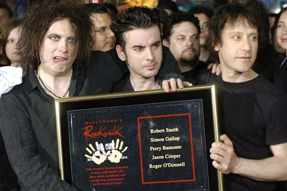 Bamonte, right, with Robert Smith, left, and Simon Gallup, after The Cure was inducted into Hollywood’s Rockwalk in 2004.