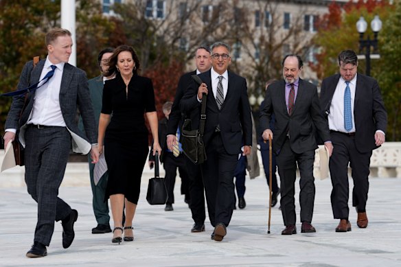 Attorney Neal Katyal, centre, and Victor Schwartz (second from right), the lead plaintiff suing President Donald Trump.