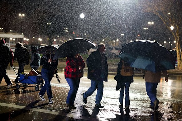 Attendees walk to the parking lot at the Fort Worth Stock Show & Rodeo ahead of an anticipated winter storm in Fort Worth, Texas on Friday.