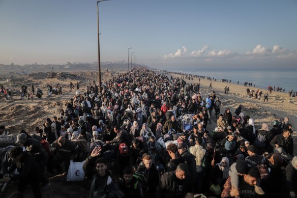 Thousands of displaced Palestinians walk towards their homes in northern Gaza, via the Netzarim Corridor, during the ceasefire in central Gaza, on Monday.