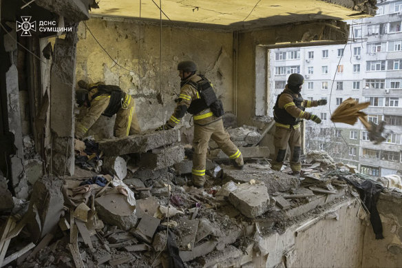 Ukrainian rescuers search for civilians killed when a Russian drone hit an apartment building in Sumy last week.