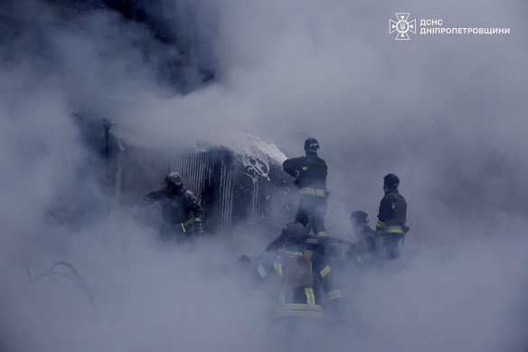 Firefighters put out the fire following a Russian missile attack on the country’s energy system in Dnipropetrovsk region, Ukraine, on Christmas Day.