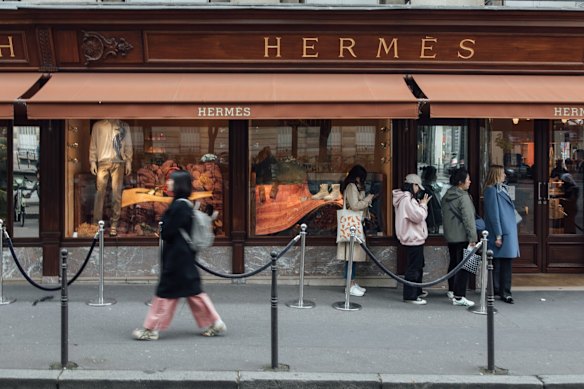Shoppers  outside the Hermes International luxury clothing boutique on Avenue George V in central Paris, France.