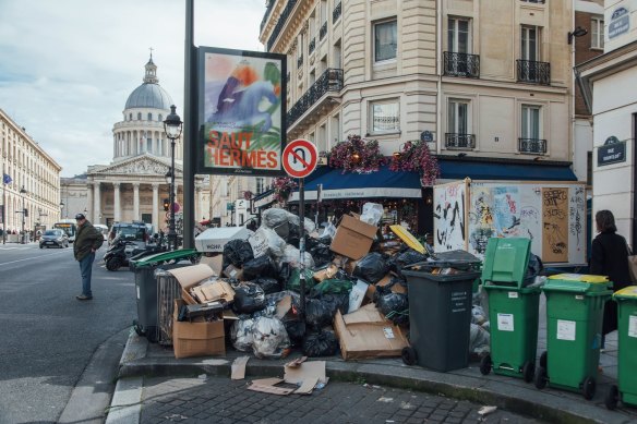 Uncollected garbage lines a Parisian street during a sanitation workers’ strike in 2023.