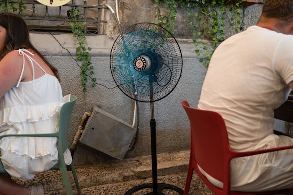 A fan at an outdoor restaurant during a heatwave in Palermo.