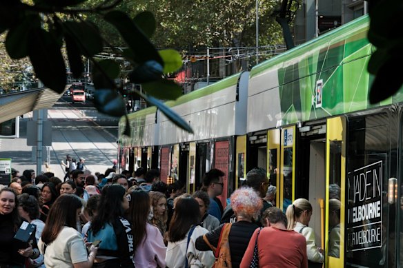 Crowds board a tram in Melbourne.
