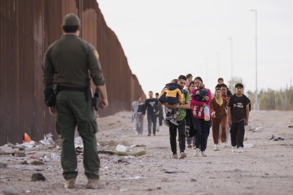 Migrants arrive at the U.S.-Mexico border in Lukeville, Arizona, on Monday.