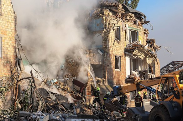 Emergency service workers at the site of a Russian air strike on a residential building in Kyiv, Ukraine, in August.