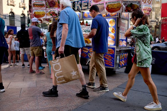 A pedestrian carries a Macy’s Inc. shopping bag in New York on Tuesday.