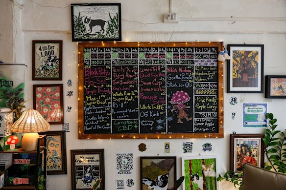 A blackboard illustrating cannabis strains for sale inside a dispensary in Bangkok.