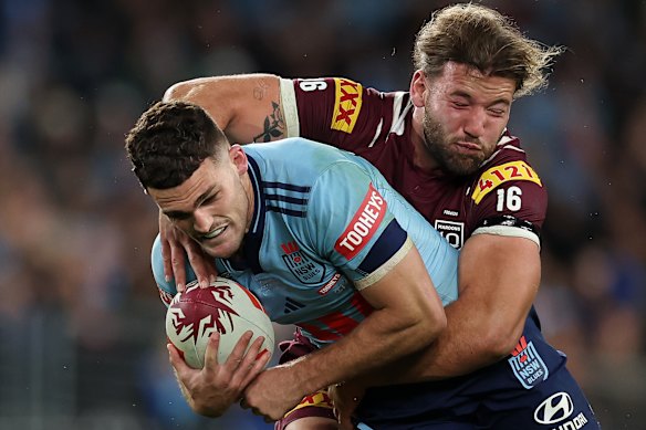 Nathan Cleary is wrapped up by Maroons forward Pat Carrigan.