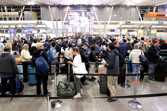 Passengers queue at Jetstar Airways’ check-in area at Sydney Airport in 2024.