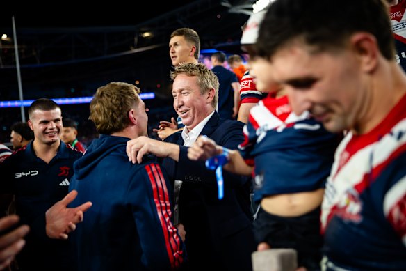 Coach Trent Robinson celebrates with the Roosters players.