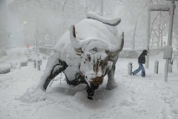 Snow covers the famous Charging Bull.