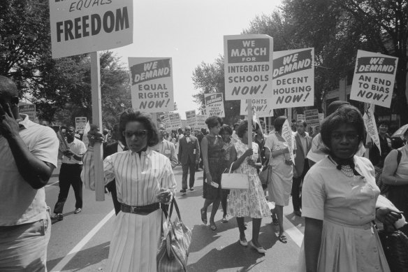 Same old story ... context is everything. Black Americans carry signs for equal rights, integrated schools, decent housing, and an end to bias in the early 1960s. 
