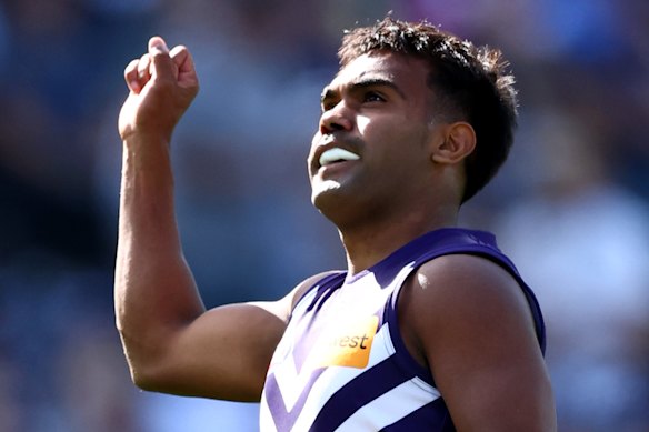 Isaiah Dudley of the Dockers celebrates kicking a goal.