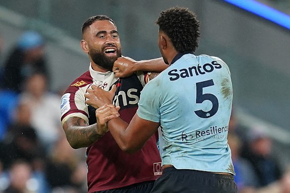 Miles Amatosero tangles with Lukhan Salakaia-Loto in the last Waratahs-Reds clash, in round 13 last year.