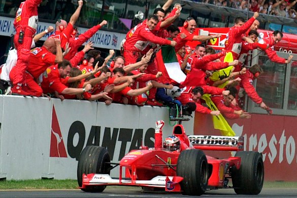 The Ferrari crew cheer home Michael Schumacher as he takes victory in the Australian GP in 2000.