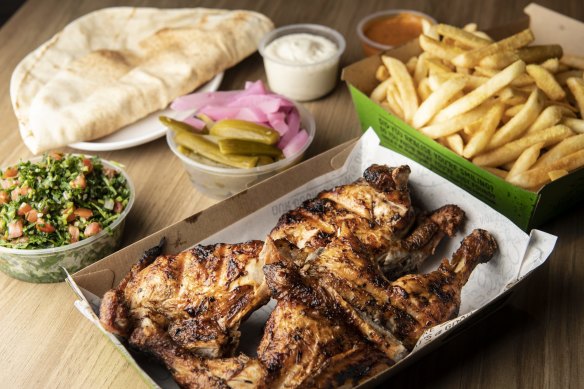 The essentials: whole charcoal chicken meal with Lebanese pickles, bread, tabouli, garlic dip, and fries.
