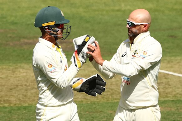 Alex Carey and Nathan Lyon in action for Australia. 