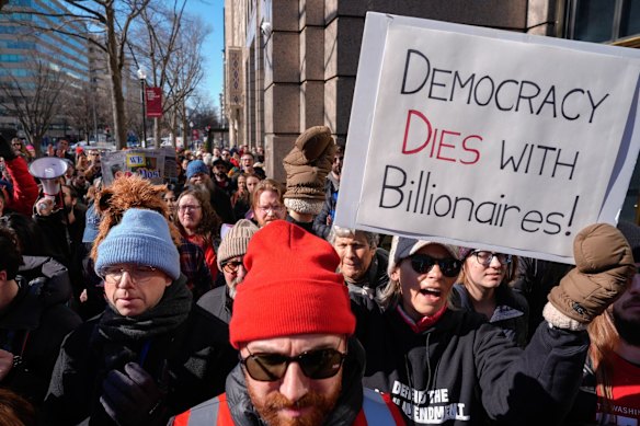 Protesters outside The Washington Post building on Thursday, after the paper announced massive job cuts.