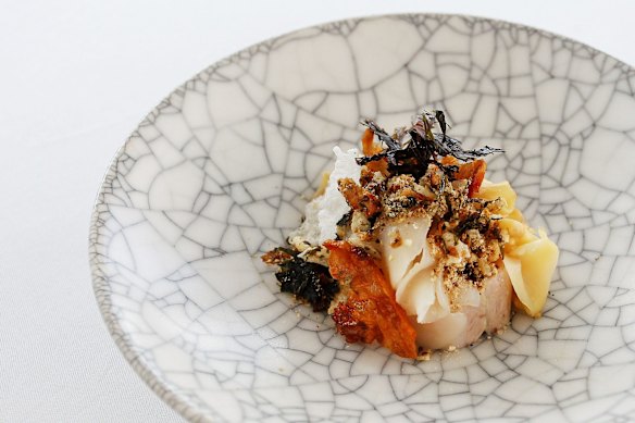 A dish of smoked confit pig jowl, roasted koji, shiitake, kombu, sea scallop and sesame at Quay in 2014.