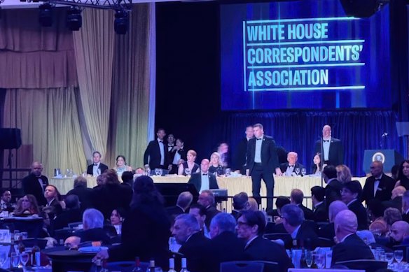 US Secret Service agents rush to the stage where US President Donald Trump was seated at the White House Correspondents’ Dinner.