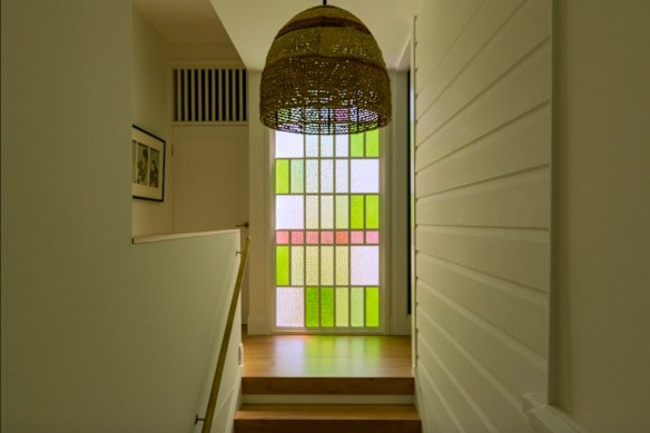 Coloured textured glass from the front of the home was salvaged in the rebuild and turned into a feature window.