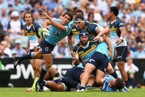 Nick Phipps passes in a 2015 game for the Waratahs.