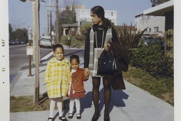 This January 1970 photo provided by the Kamala Harris campaign shows her, left, with her sister, Maya, and mother, Shyamala, outside their apartment in Berkeley, California, after her parents’ separation.