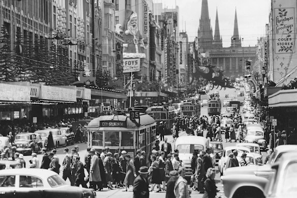 Christmas decorations and shoppers on Bourke Street, near the corner of Swanston Street, Melbourne, on December 4, 1957. 
