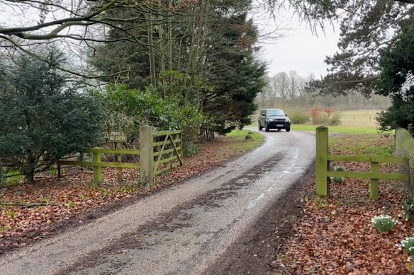 A car moves out of the Royal estate in Sandringham.