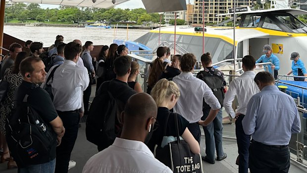 Passengers mill at a Brisbane River ferry terminal after being told to alight from a CityCat.
