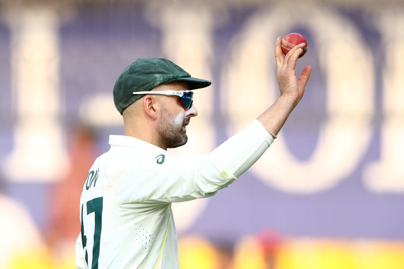 Nathan Lyon holds up the ball after he took eight wickets in the second innings during day two of the third Test match in the series between India and Australia in Indore, India.
