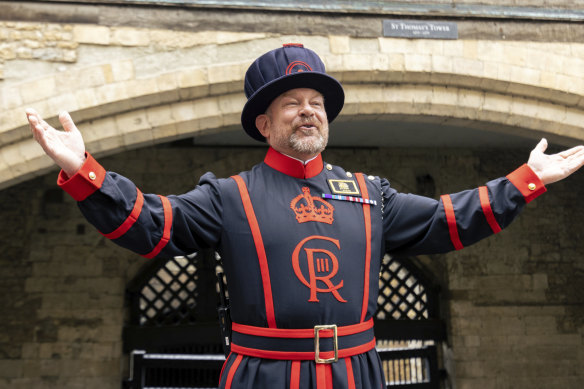 A guard at the Tower of London wears a new uniform featuring the royal cypher of King Charles III.
