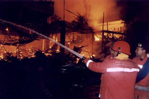 Firefighters respond to the bomb blast at the Sari night club on Kuta Beach on October 12, 2002.