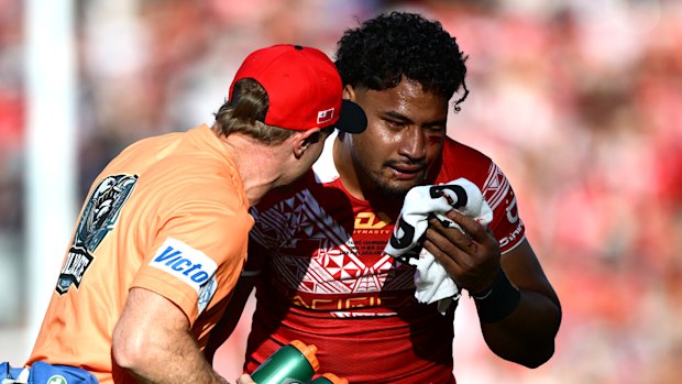 Eli Katoa is helped from the field after a head knock while playing for Tonga.