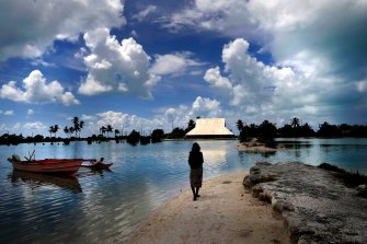 On the Pacific island of Abaiang, people must use a boat to cross from one side of a village to another at high tide as the sea creeps further in.