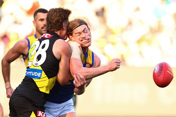 The Tigers Kane McAuliffe lays a bonecrunching Tigers tackle that slows West Coast’s Harley Reid.