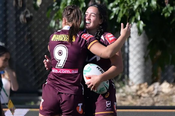 Kerri Johnson celebrates scoring one of her two tries on her NRLW debut.