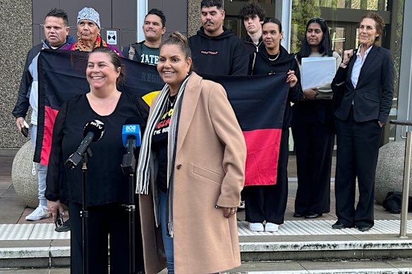 Raelene Cooper, lawyers and supporters address media outside the Federal Court in Sydney this morning.
