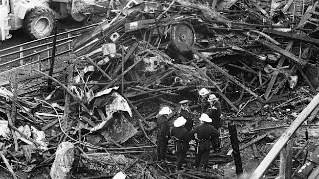 Firefighters amid the charred remains of the Ghost Train.